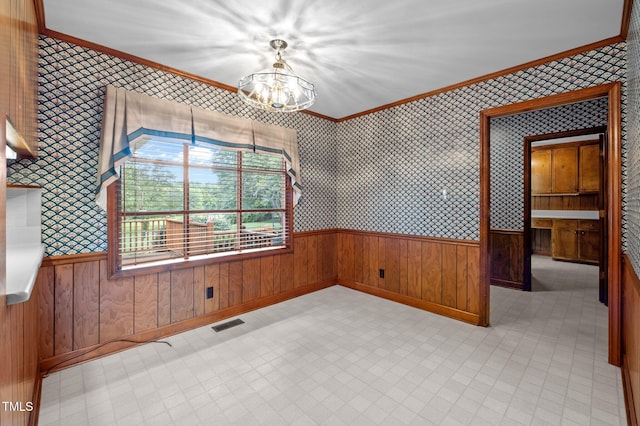 913 Milton Rd, Durham, NC 27712 - spare room with a chandelier, ornamental molding, wallpapered walls, a wainscoted wall, and light flooring