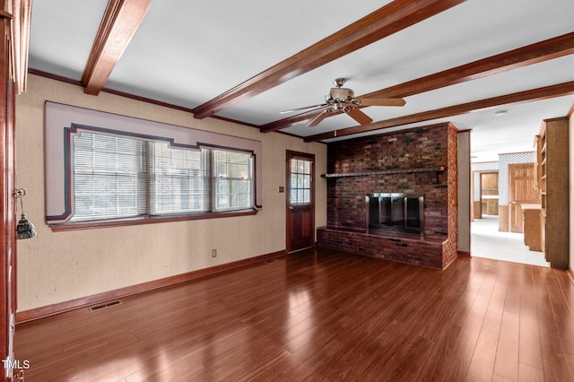 913 Milton Rd, Durham, NC 27712 - unfurnished living room featuring beam ceiling, a fireplace, ceiling fan, and wood-type flooring