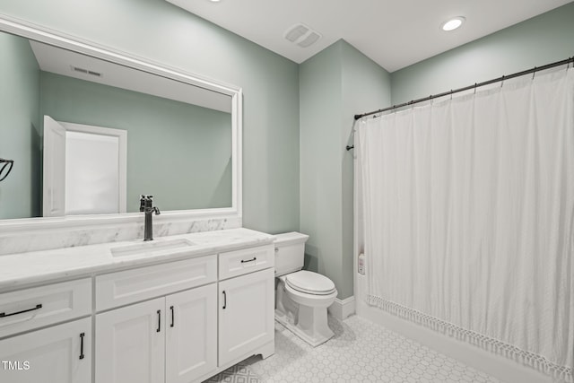 bathroom featuring toilet, vanity, and a shower with shower curtain