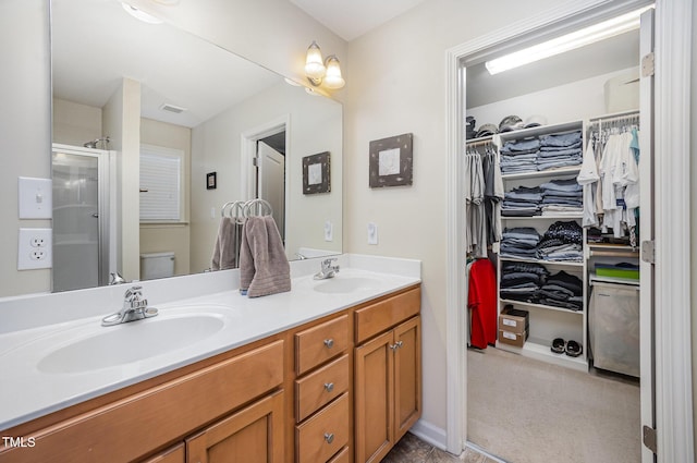 59 Long Grass Dr, Smithfield, NC 27577 - bathroom featuring double vanity, a shower stall, toilet, and a walk in closet