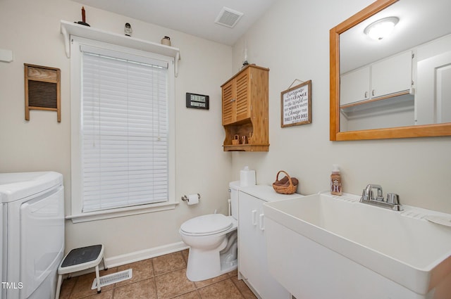 59 Long Grass Dr, Smithfield, NC 27577 - bathroom with toilet, a sink, independent washer and dryer, tile patterned flooring, and baseboards