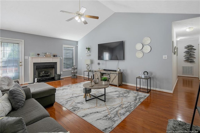 4829 Miranda Dr, Hope Mills, NC 28348 - living area featuring a ceiling fan, wood finished floors, high vaulted ceiling, baseboards, and a fireplace with flush hearth