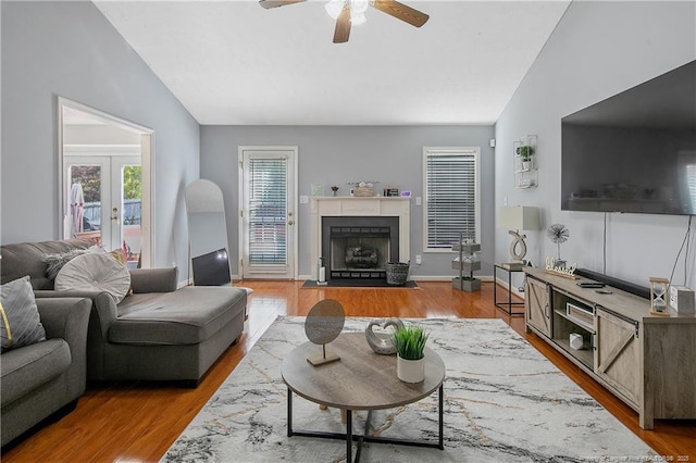 4829 Miranda Dr, Hope Mills, NC 28348 - living room featuring lofted ceiling, ceiling fan, wood finished floors, a fireplace with flush hearth, and french doors