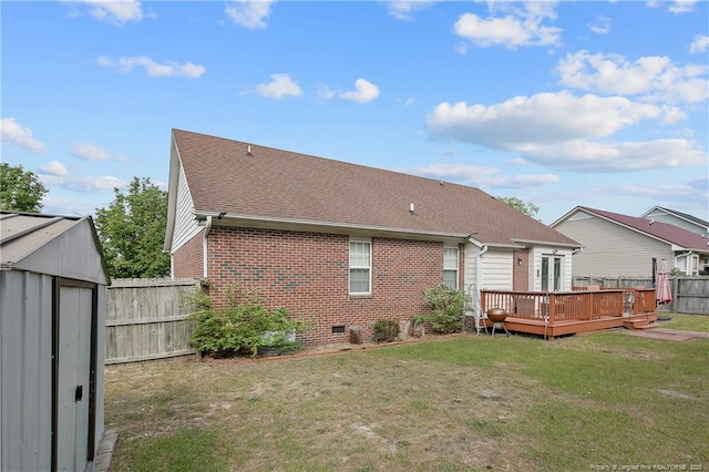 4829 Miranda Dr, Hope Mills, NC 28348 - rear view of property with brick siding, a deck, a storage shed, a shingled roof, and an outbuilding