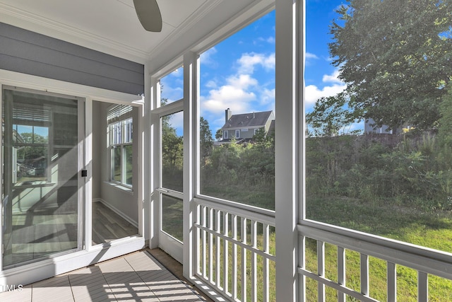unfurnished sunroom with crown molding