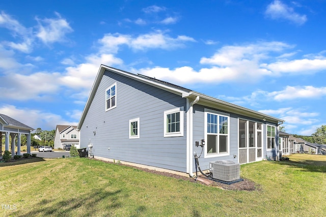 view of property exterior featuring cooling unit and a lawn