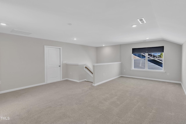 spare room with carpet floors, vaulted ceiling, baseboards, and recessed lighting