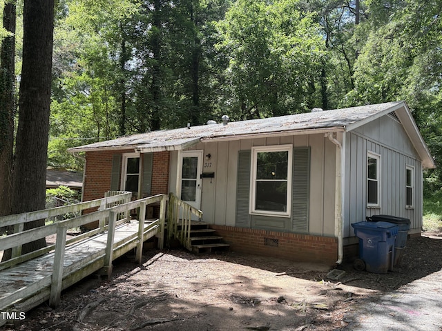 view of front of house featuring board and batten siding and a wooden deck