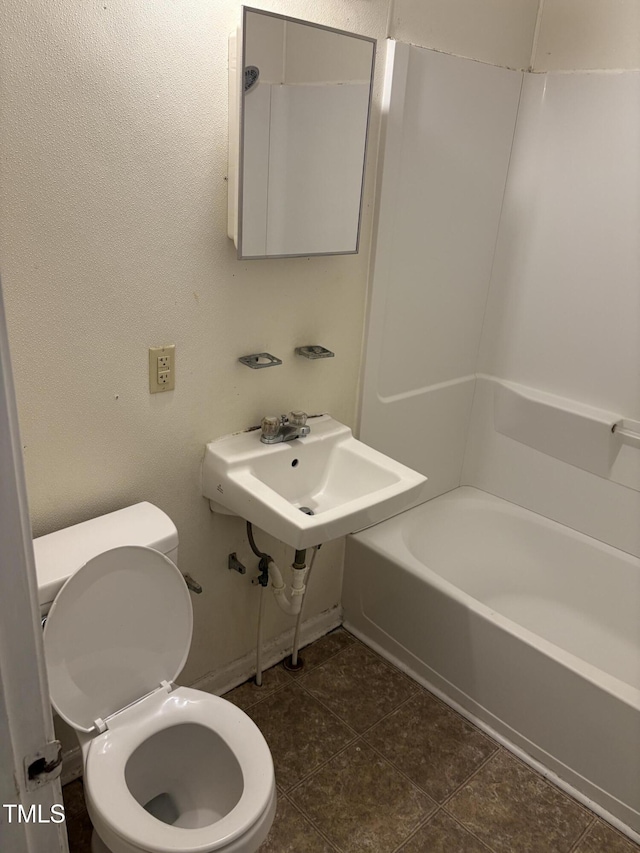 full bathroom with toilet, a sink, tile patterned floors, bathtub / shower combination, and baseboards