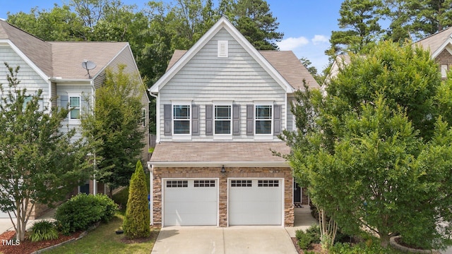 2057 Tanners Mill Dr, Durham, NC 27703 - view of front of property featuring a garage, concrete driveway, stone siding, and roof with shingles