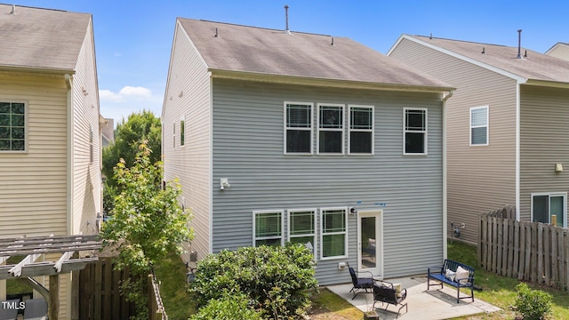 2057 Tanners Mill Dr, Durham, NC 27703 - rear view of house with a patio and roof with shingles