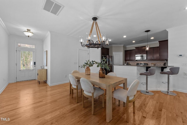 2057 Tanners Mill Dr, Durham, NC 27703 - dining area with crown molding, a chandelier, baseboards, light wood-type flooring, and recessed lighting