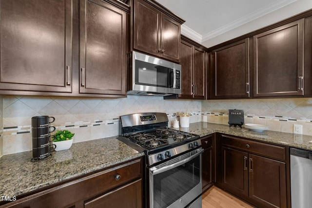 2057 Tanners Mill Dr, Durham, NC 27703 - kitchen featuring stainless steel appliances, dark stone counters, ornamental molding, dark brown cabinets, and backsplash