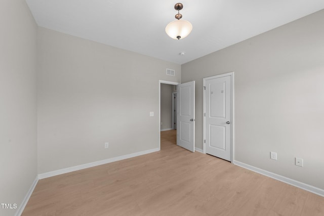 2057 Tanners Mill Dr, Durham, NC 27703 - unfurnished bedroom with light wood-style flooring and baseboards
