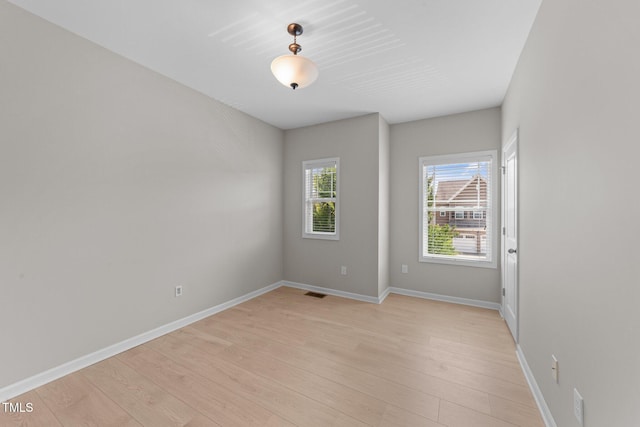 2057 Tanners Mill Dr, Durham, NC 27703 - spare room featuring light wood-type flooring and baseboards