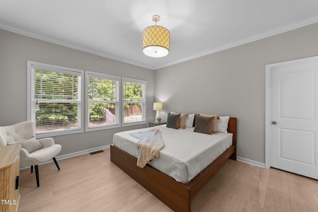 2057 Tanners Mill Dr, Durham, NC 27703 - bedroom with light wood-style flooring, baseboards, and crown molding