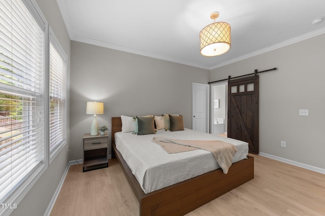 2057 Tanners Mill Dr, Durham, NC 27703 - bedroom with multiple windows, light wood finished floors, ornamental molding, baseboards, and a barn door