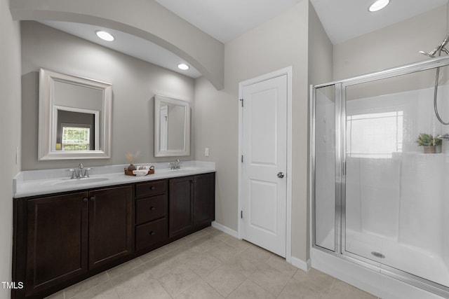 2057 Tanners Mill Dr, Durham, NC 27703 - full bathroom featuring a stall shower, double vanity, tile patterned flooring, baseboards, and recessed lighting