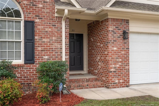 35 Shining Water Ln, Spring Lake, NC 28390 - property entrance with brick siding, an attached garage, and a shingled roof