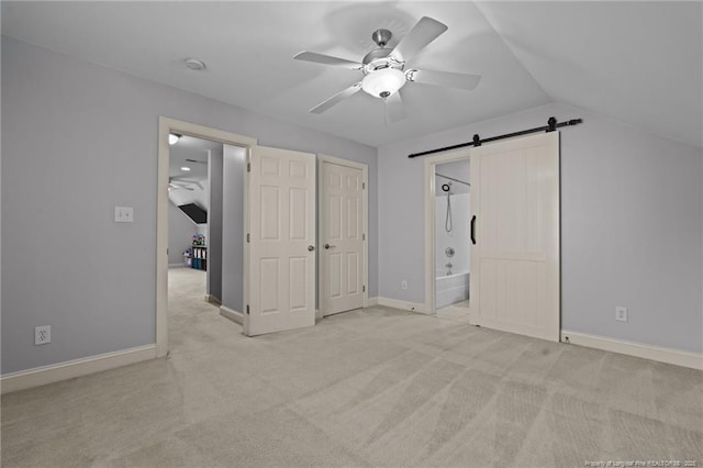 35 Shining Water Ln, Spring Lake, NC 28390 - unfurnished bedroom featuring carpet, a barn door, vaulted ceiling, baseboards, and ensuite bathroom