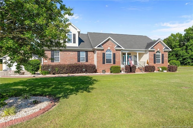 view of front of property featuring brick siding, a front lawn, and a porch
