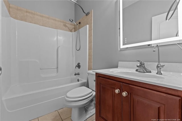 bathroom with toilet, tile patterned floors, vanity, and bathing tub / shower combination
