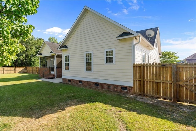 rear view of property with crawl space, entry steps, and a sunroom