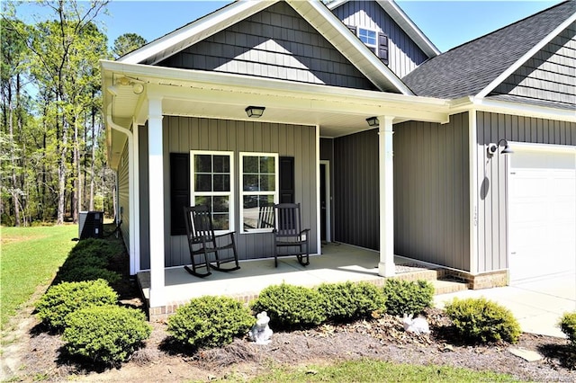 120 Will Lucas Rd, Linden, NC 28356 - back of house with a porch, an attached garage, roof with shingles, and central air condition unit