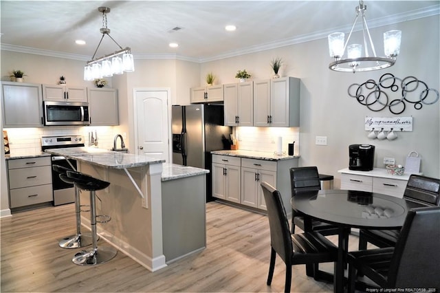120 Will Lucas Rd, Linden, NC 28356 - kitchen with stainless steel appliances, gray cabinetry, a center island with sink, light wood finished floors, and recessed lighting