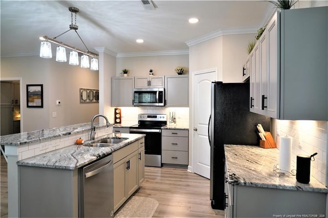 120 Will Lucas Rd, Linden, NC 28356 - kitchen with stainless steel appliances, a sink, crown molding, gray cabinetry, and light wood-style flooring