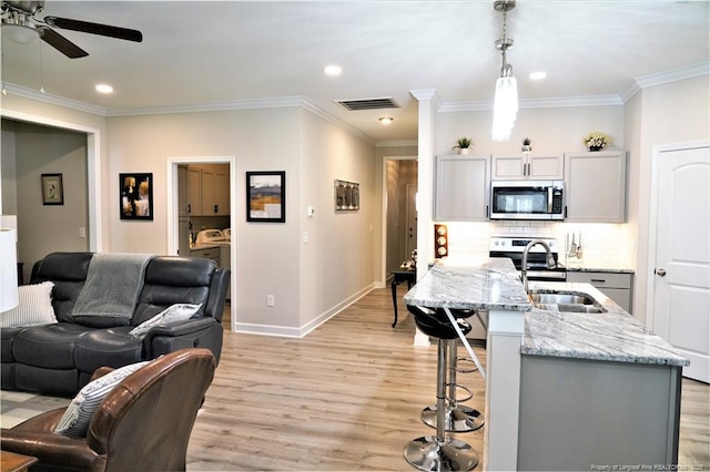 120 Will Lucas Rd, Linden, NC 28356 - kitchen with appliances with stainless steel finishes, ceiling fan, light wood-style floors, light stone countertops, and ornamental molding
