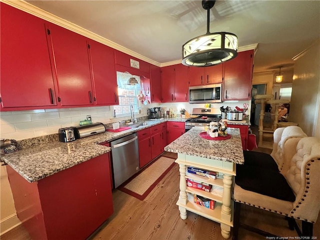 12558 Mcdougald Rd, Broadway, NC 27505 - kitchen with red cabinets, appliances with stainless steel finishes, a sink, light wood-style floors, and backsplash