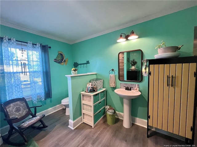 12558 Mcdougald Rd, Broadway, NC 27505 - half bath featuring wood finished floors, ornamental molding, toilet, baseboards, and a sink