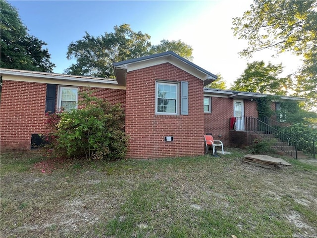 12558 Mcdougald Rd, Broadway, NC 27505 - view of home's exterior featuring crawl space, brick siding, and a yard