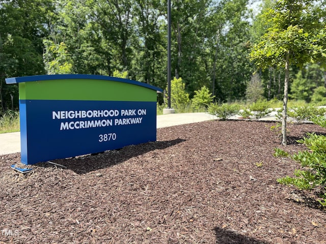 community / neighborhood sign featuring view of scattered trees