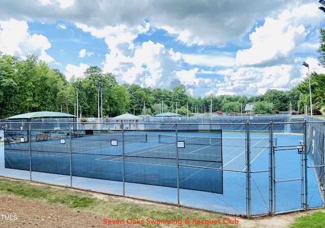 view of tennis court featuring fence