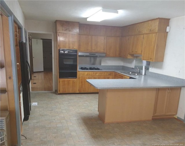 1829 Martindale Dr, Fayetteville, NC 28304 - kitchen featuring black appliances, a sink, a peninsula, light countertops, and a warming drawer
