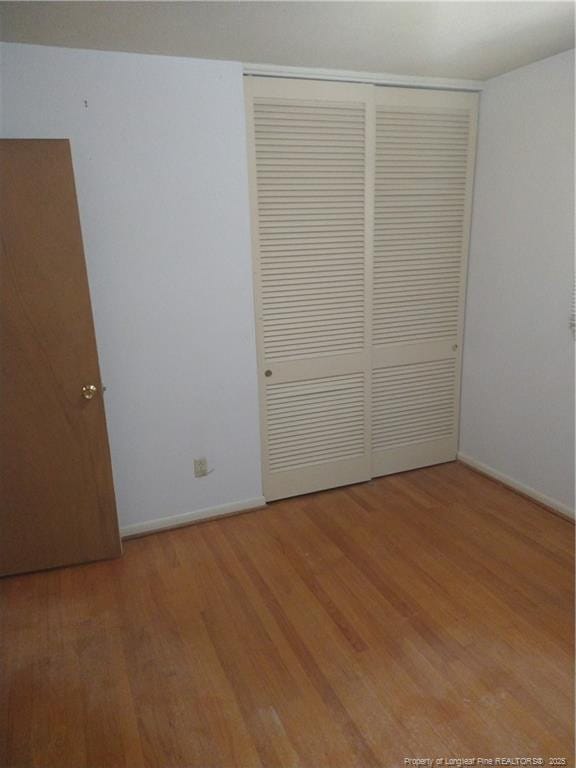 1829 Martindale Dr, Fayetteville, NC 28304 - unfurnished bedroom with light wood-style flooring, a closet, and baseboards