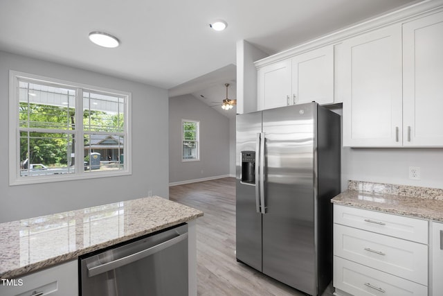 208 W Holt St, Burlington, NC 27217 - kitchen featuring appliances with stainless steel finishes, a ceiling fan, light wood finished floors, white cabinetry, and light stone countertops