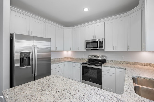 208 W Holt St, Burlington, NC 27217 - kitchen featuring appliances with stainless steel finishes, white cabinets, light stone countertops, recessed lighting, and a sink