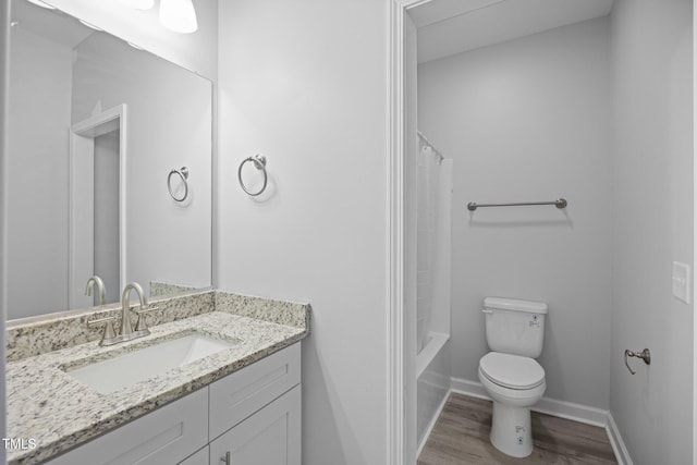 208 W Holt St, Burlington, NC 27217 - bathroom with wood finished floors, toilet, vanity, baseboards, and shower / tub combo with curtain