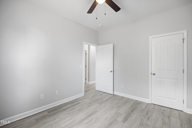 208 W Holt St, Burlington, NC 27217 - unfurnished bedroom with wood finished floors, baseboards, and ceiling fan