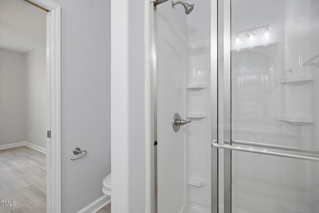 208 W Holt St, Burlington, NC 27217 - full bathroom featuring a shower stall, baseboards, wood finished floors, and toilet