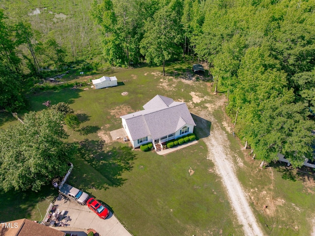 aerial view of property's location featuring a forest