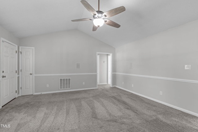 unfurnished bedroom with lofted ceiling, carpet floors, baseboards, and a ceiling fan