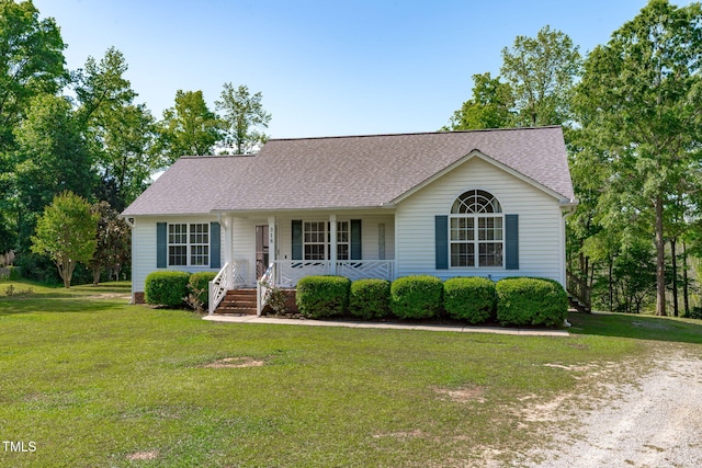 view of front facade with a porch, a front yard, and a shingled roof
