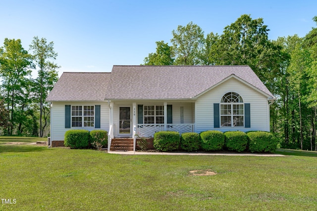 view of front of house with covered porch, a front yard, and roof with shingles