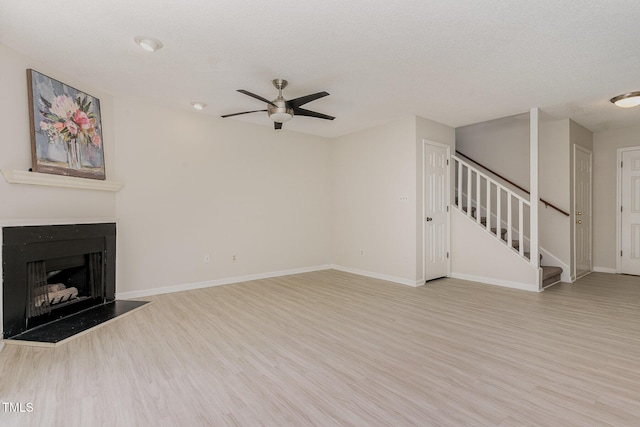 509 Darby Glen Ln, Durham, NC 27713 - unfurnished living room with ceiling fan, stairway, wood finished floors, and baseboards