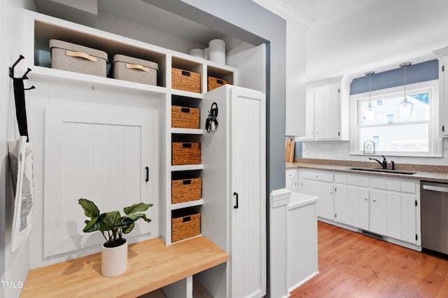 mudroom with a sink and light wood-style floors
