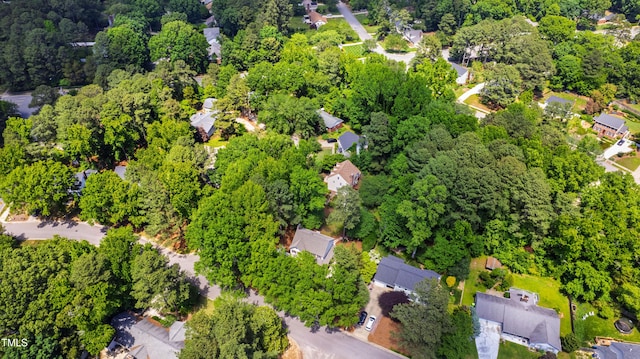 aerial view of property and surrounding area featuring nearby suburban area